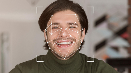 A smiling individual is displayed within a digital facial recognition framework, showcasing advanced identification technology.