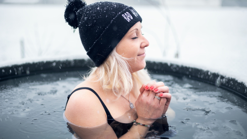 Woman in hat taking an ice bath.