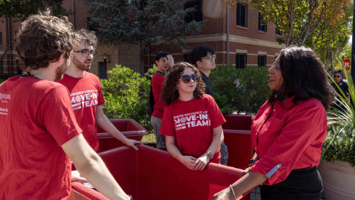 Rutgers-New Brunswick Chancellor Francine Conway (right) speaks with student members of the Residence Life move-in team Monday outside BEST Hall.