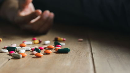 Pills near an empty hand after suicide