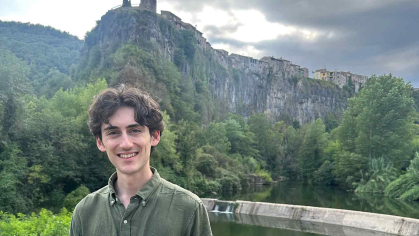 Rutgers-New Brunswick graduate Joe Mezza stands before hilly, lush terrain in Catalonia, Spain, where he took part in excavations at several archaeological sites.
