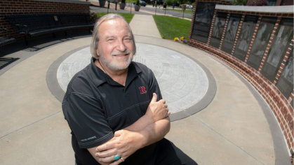 Jim Savage sitting in the Paul Robeson monument 
