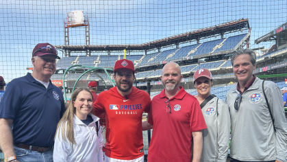 Alumni Bob White (left) and Mark O'Connor (right) with his wife, Susan, and Philadelphia Phillies player Kyle Schwarber (center), a supporter of the Families Behind the Badge Children’s Foundation
