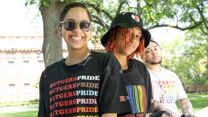 Models wearing Rutgers Pride tees and hats 