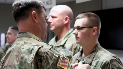 At right, Daylen Osmer, who was a private first class in the U.S. Army in 2018, receiving the Army Achievement Award.