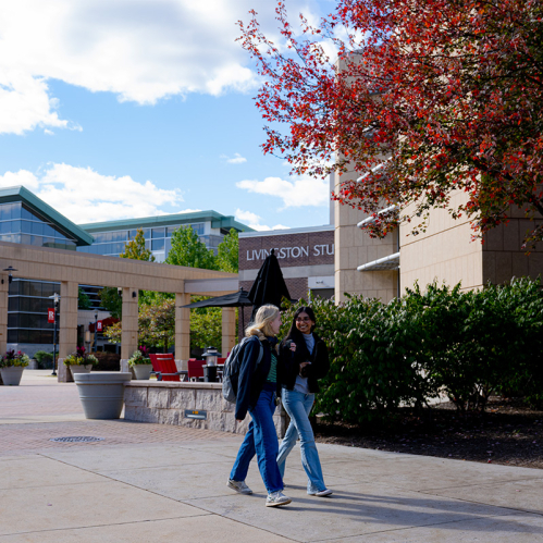 Students walk outside the Student Center on Livingston campus on a fall day