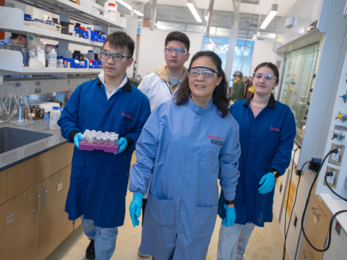 Professor and students in chemistry lab