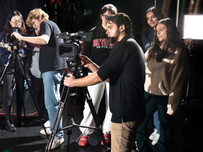 Rutgers communication students setting up cameras in a studio