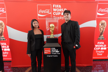 Rutgers student posing with the World Cup trophy