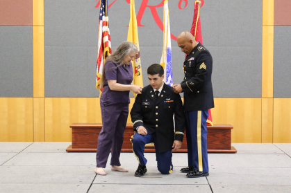 Second Lieutenant Robert Armaslandau being pinned by his parents