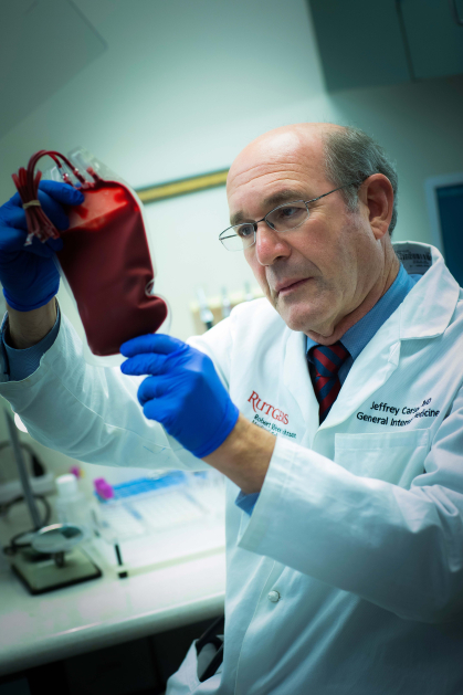 Jeffrey Carson examines blood bag