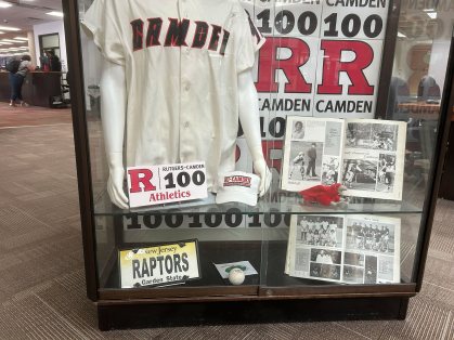 a display showing historical articfacts from Camden's 100-year history in a glass case