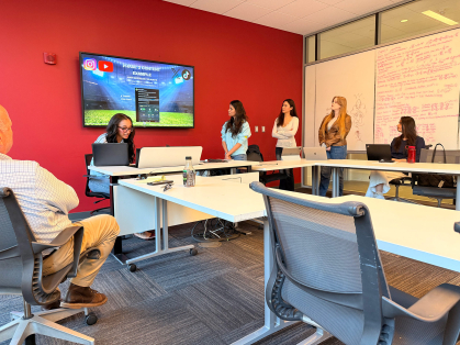 Students presenting their marketing plan to the Ironbound's business improvment district