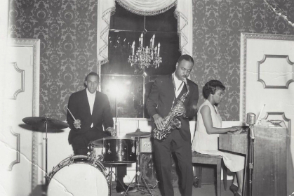 Dolores "Dee" Holland performing with her band inlcuidn Cliff Johnson on saxophone.