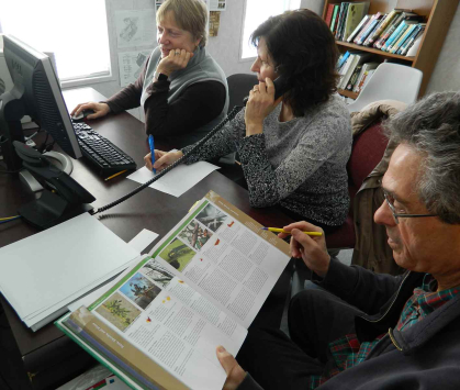 Rutgers master gardeners Maureen Merrill (left), Jean Hartley, Bernard Leleman field a call on the helpline at the Middlesex Cooperative Extension office.