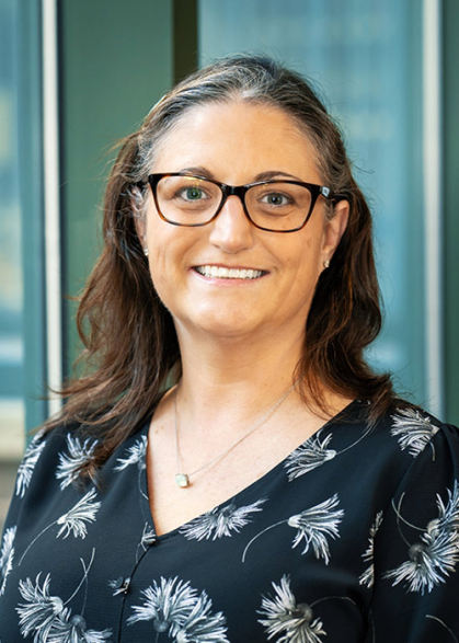Woman wearing black shirt with white flowers.