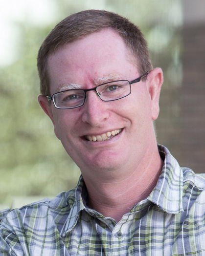 Man with a checked shirt and a green background