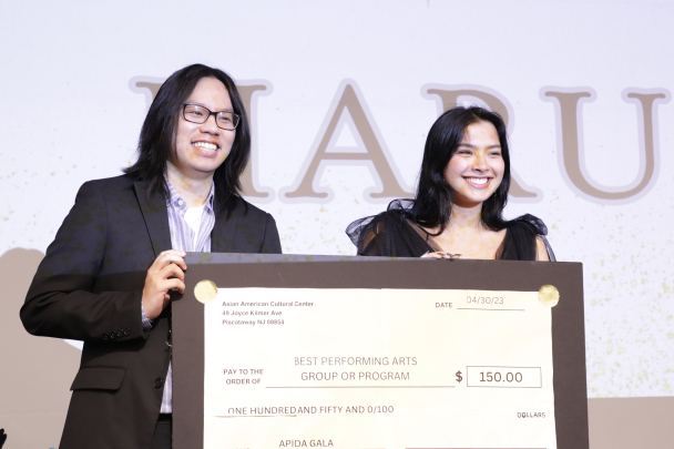 Hosts Katy Le and Roma Prasad presenting the best performing arts group or program award