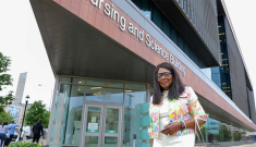 Veronica Charles in front of the nursing building